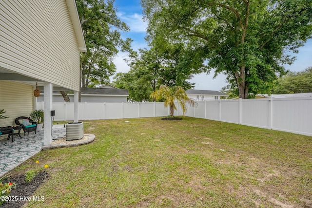 view of yard featuring a patio area, a fenced backyard, and central air condition unit