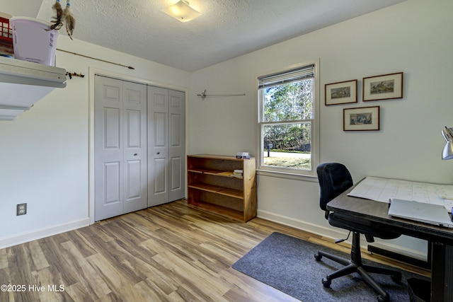 office space with wood finished floors, baseboards, and a textured ceiling