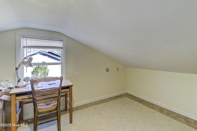 home office with lofted ceiling and baseboards