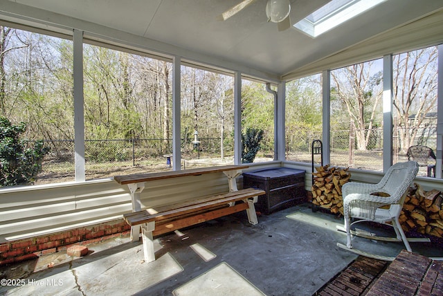 sunroom with vaulted ceiling with skylight and ceiling fan