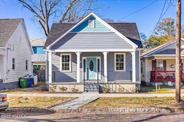 view of front of house featuring covered porch and roof with shingles