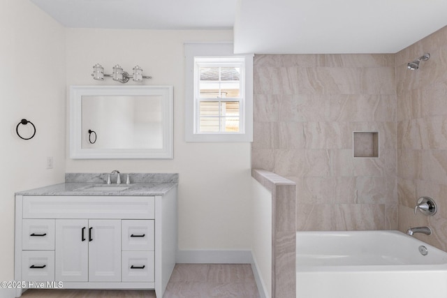 bathroom with baseboards, vanity, and shower / tub combination