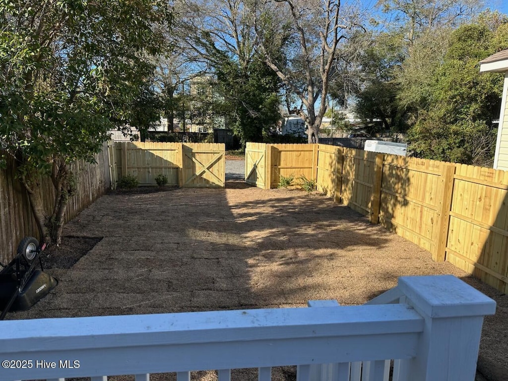 view of yard featuring a fenced backyard and a gate