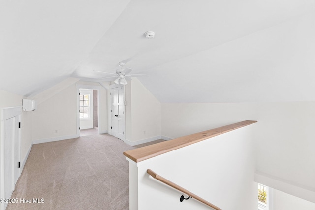 additional living space featuring ceiling fan, baseboards, vaulted ceiling, and light colored carpet