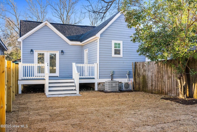 back of property featuring french doors, a fenced backyard, cooling unit, a wooden deck, and ac unit
