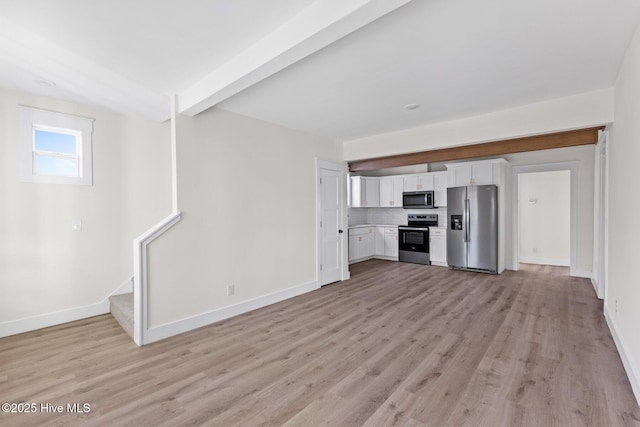 kitchen with stainless steel appliances, white cabinetry, light countertops, light wood-type flooring, and decorative backsplash