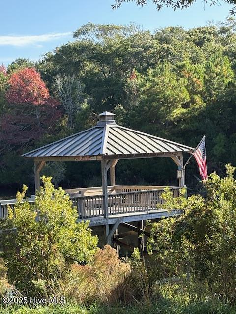 view of property's community with a deck and a gazebo