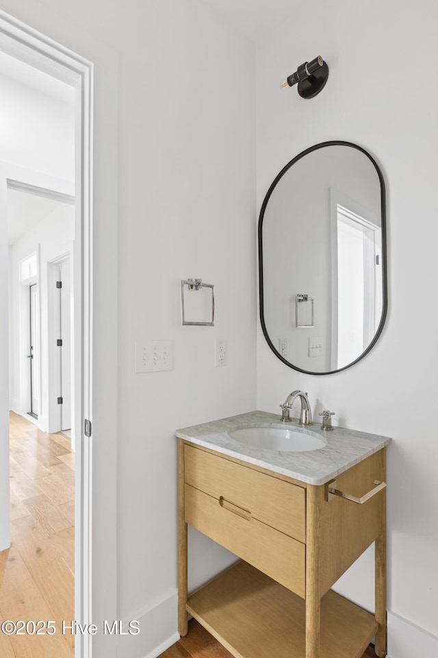 bathroom with wood finished floors and vanity