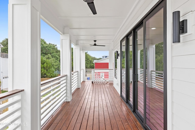 wooden deck with a ceiling fan