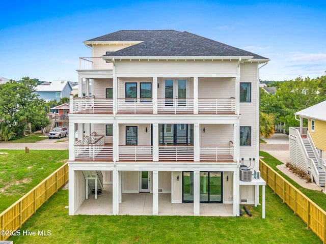 back of house with a fenced backyard, a patio, a balcony, and stairs