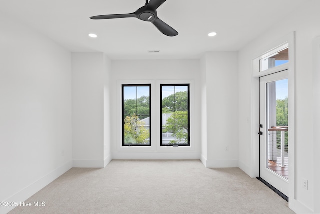 unfurnished room with recessed lighting, light colored carpet, and baseboards