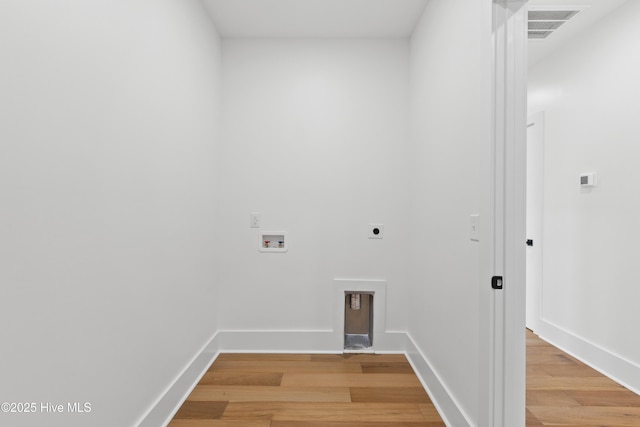 clothes washing area featuring baseboards, visible vents, light wood-style flooring, washer hookup, and electric dryer hookup