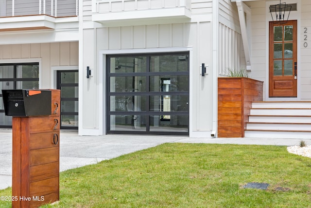 entrance to property featuring board and batten siding and a lawn