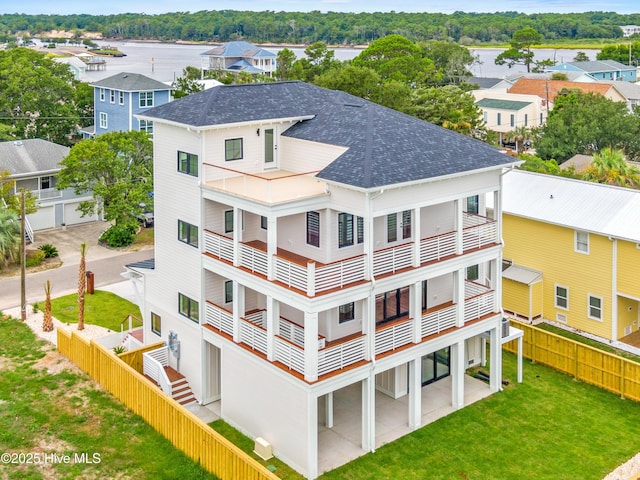 view of property with driveway, a fenced backyard, and a residential view