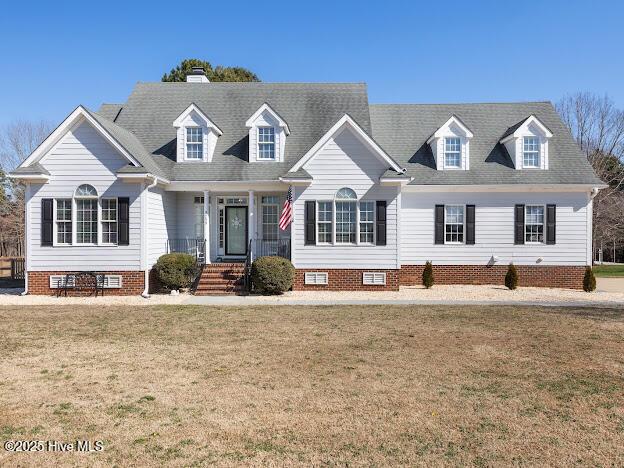 cape cod house featuring crawl space and a front lawn