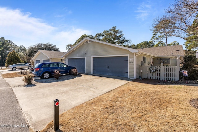 ranch-style house featuring concrete driveway and an attached garage