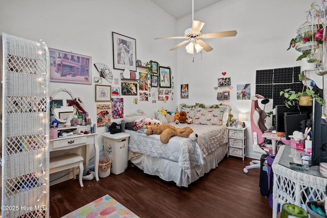 bedroom featuring ceiling fan, vaulted ceiling, and wood finished floors