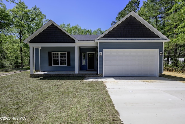 view of front of house with a front lawn, covered porch, driveway, and an attached garage