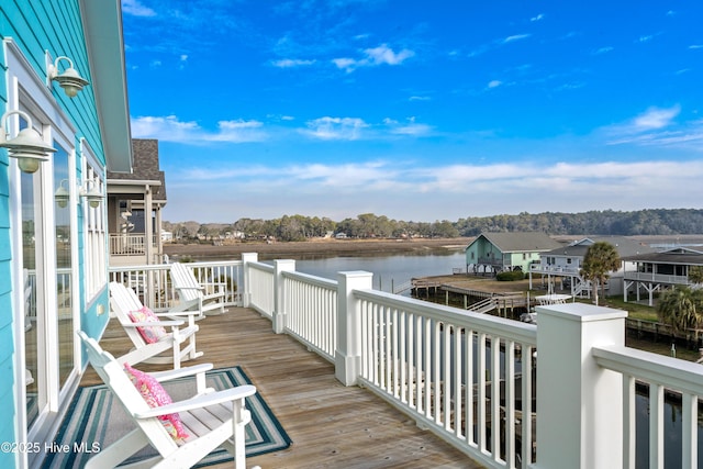 wooden terrace featuring a water view