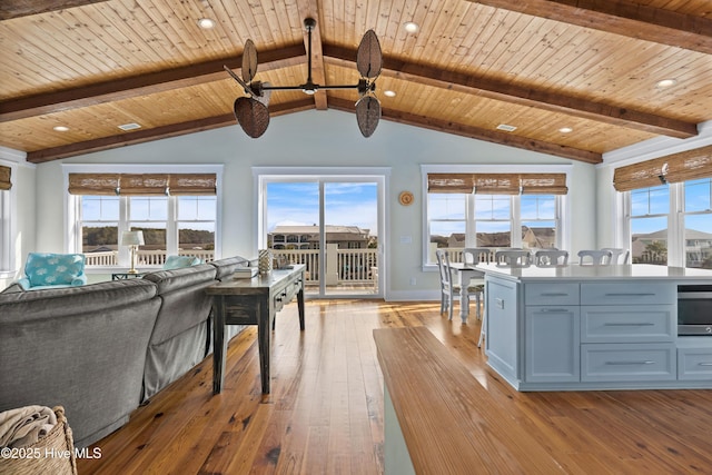 living area featuring lofted ceiling with beams, recessed lighting, wood ceiling, baseboards, and light wood-style floors