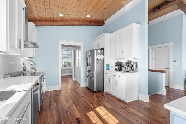 kitchen featuring white cabinetry, appliances with stainless steel finishes, decorative backsplash, and light stone counters