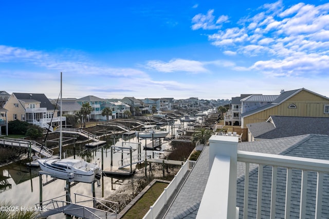 balcony featuring a boat dock, boat lift, and a residential view