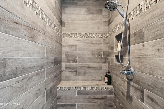 interior details featuring tiled shower