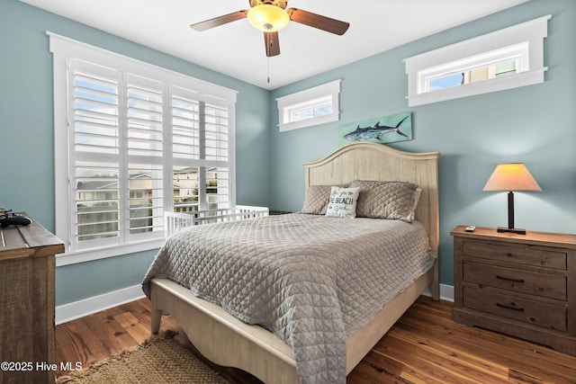 bedroom featuring a ceiling fan, baseboards, and dark wood-style flooring