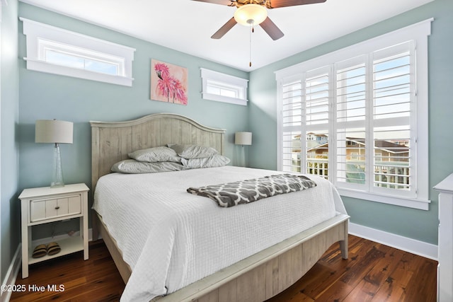 bedroom with ceiling fan, baseboards, and dark wood-style flooring