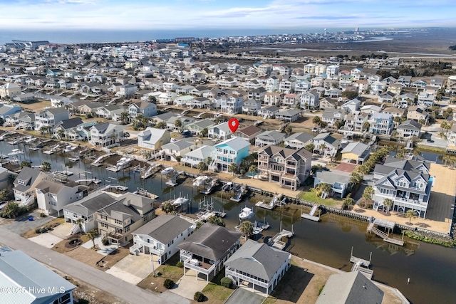 drone / aerial view featuring a residential view and a water view