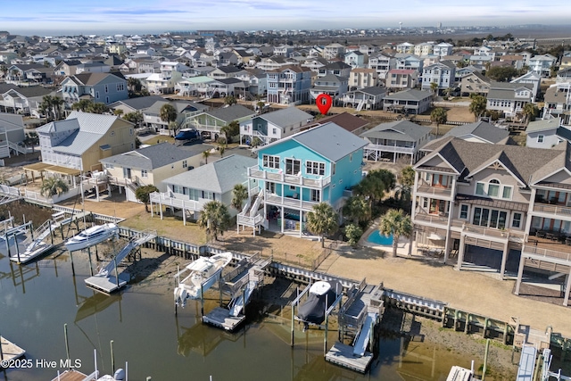 bird's eye view with a water view and a residential view