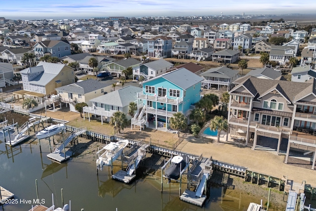 drone / aerial view featuring a water view and a residential view