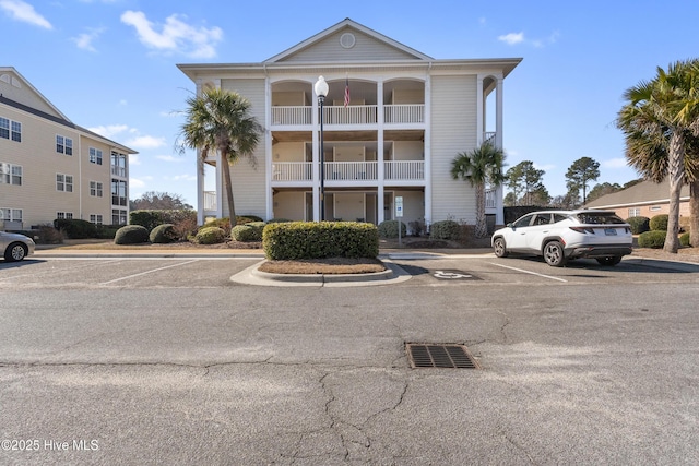 view of property featuring uncovered parking