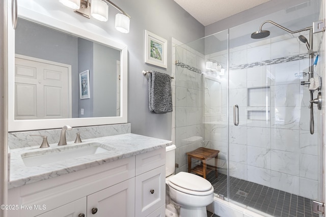 full bath with vanity, a shower stall, and toilet