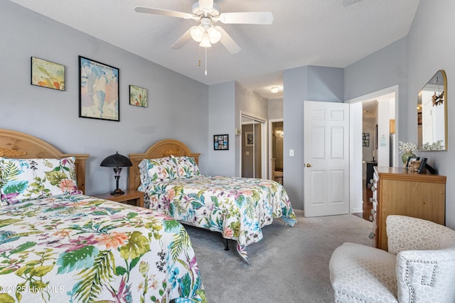 bedroom with a textured ceiling, carpet floors, and a ceiling fan