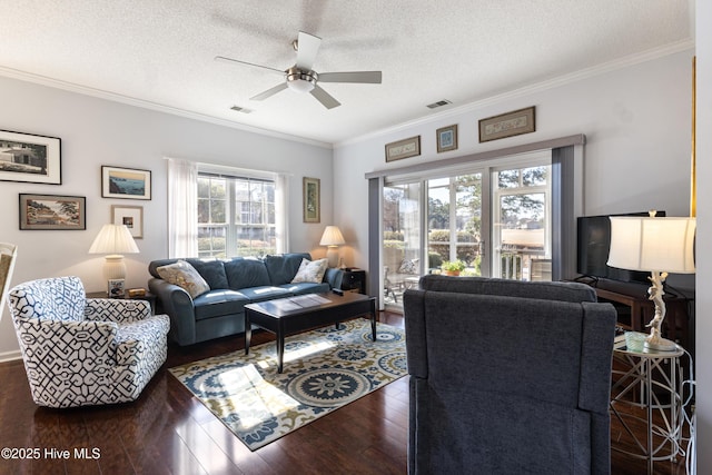 living room featuring crown molding, a textured ceiling, visible vents, and hardwood / wood-style floors