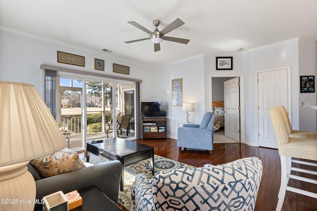 living room with ceiling fan, crown molding, baseboards, and wood finished floors