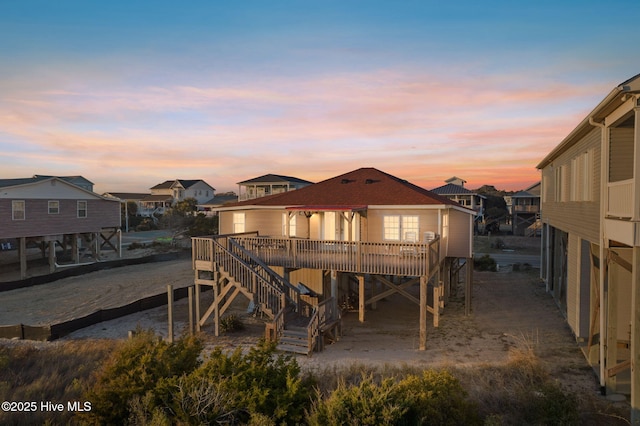 back of property featuring a residential view, stairway, and a wooden deck