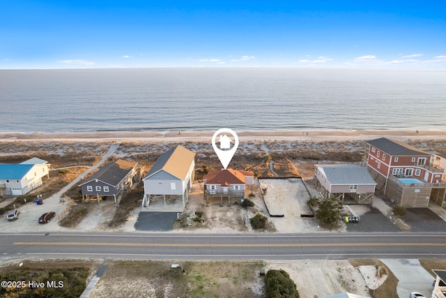 aerial view with a water view, a residential view, and a view of the beach