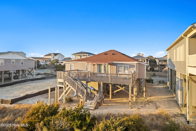 rear view of house with a residential view, a deck, and stairs