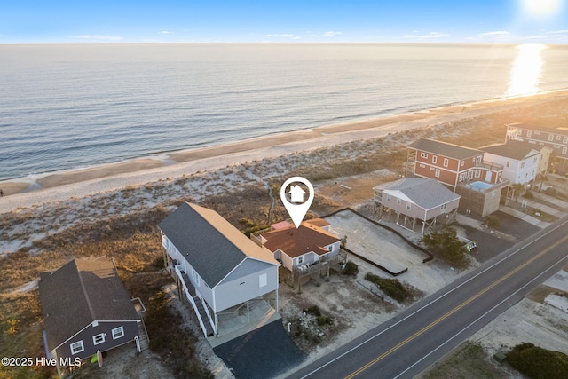 bird's eye view featuring a water view and a beach view