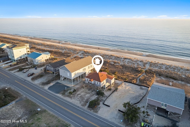 drone / aerial view featuring a water view and a beach view