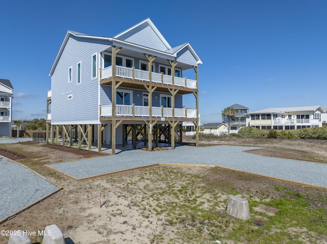 beach home with a carport, driveway, and a balcony