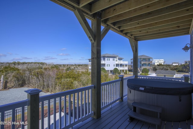 deck with a residential view and a hot tub