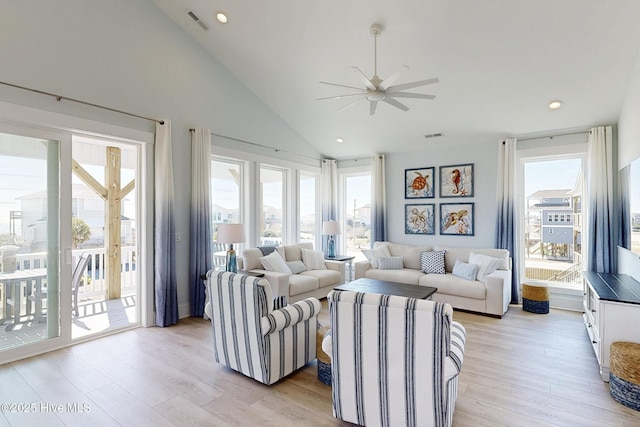 living area featuring high vaulted ceiling, light wood finished floors, a ceiling fan, and recessed lighting