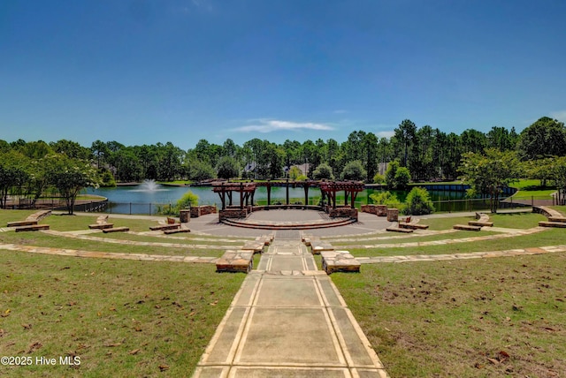 view of home's community featuring a water view and a lawn