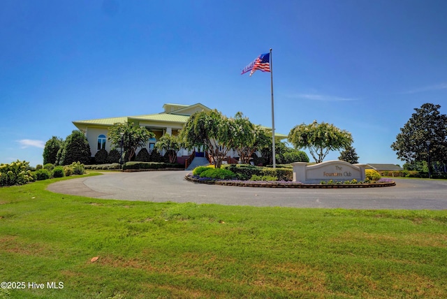 view of building exterior with aphalt driveway