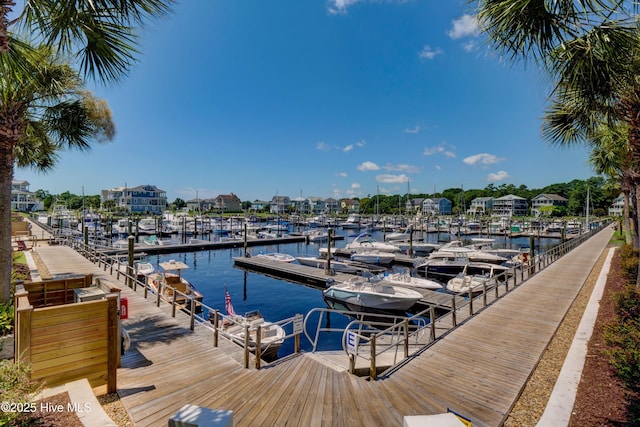 dock area featuring view of marina and a water view