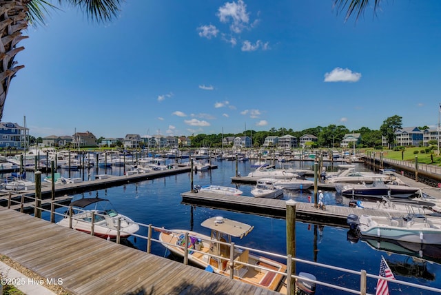 dock area featuring view of marina and a water view