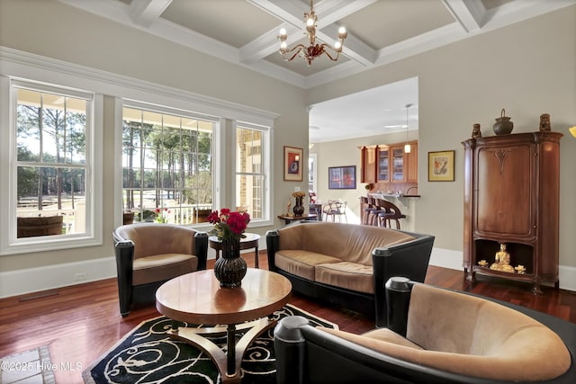 living area with coffered ceiling, dark wood-style flooring, a healthy amount of sunlight, and a notable chandelier